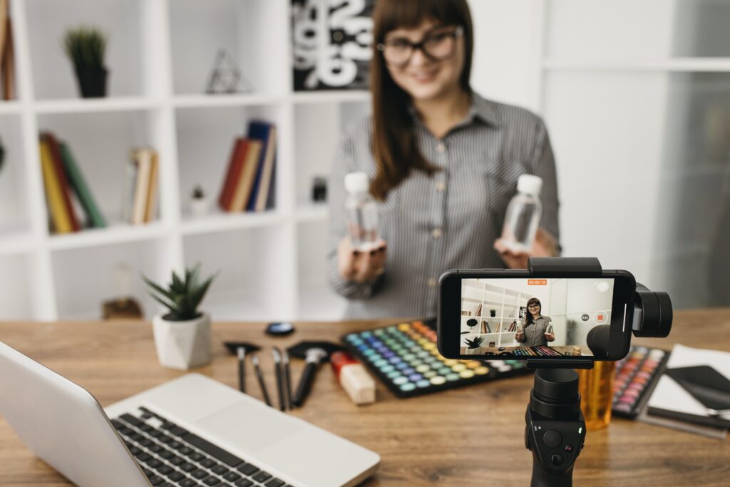A woman shooting herself showcasing makeup products, sitting in an aesthetic room